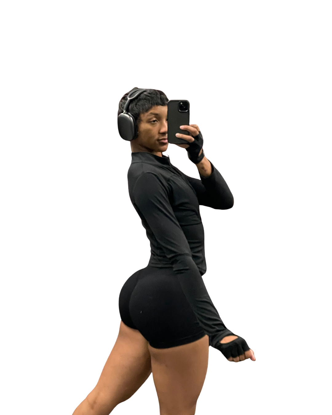 Person wearing a black athletic outfit with earphones and gloves, taking a selfie.